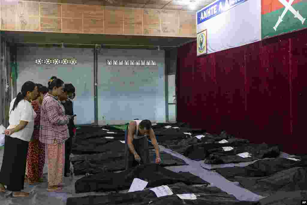 Family members check the bodies of relatives before being buried at a hospital in the town of Laiza, Myanmar. Myanmar’s military is accused of launching an airstrike on a camp for displaced persons in the northern state of Kachin that killed about 30 people, including about a dozen children. (AP Photo)
