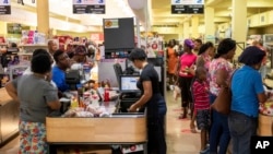 Costumers purchase groceries ahead of Hurricane Beryl in Arnos Vale, St. Vincent and the Grenadines, June 30, 2024.