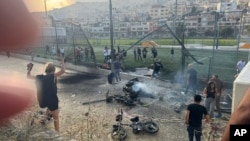 Residents rush to help injured children moments after a rocket attack hit a soccer field in the Druze town of Majdal Shams in the Israeli-controlled Golan Heights, July 27, 2024.