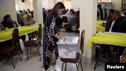 FILE - A woman casts her ballot during the general election in Dhaka, Bangladesh Dec. 30, 2018. 