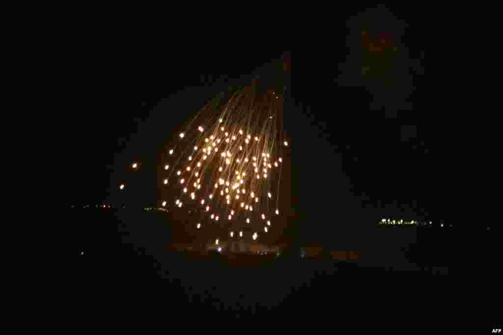 An Israeli strike illuminates the sky above the southern Lebanese village of Khiam late on April 17, 2024. Lebanon's official National News Agency reported that Israel attacked south Lebanon's Marjayoun district and the villages of Khiam and Kfar Kila with "strikes and heavy artillery and phosphorus" overnight.