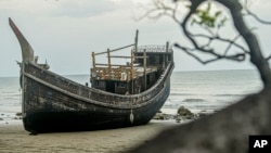 The boat used to carry a group of Rohingya Muslims sits on the beach where it landed on Dec. 10 in Pidie, Aceh province, Indonesia, Dec. 16, 2023.