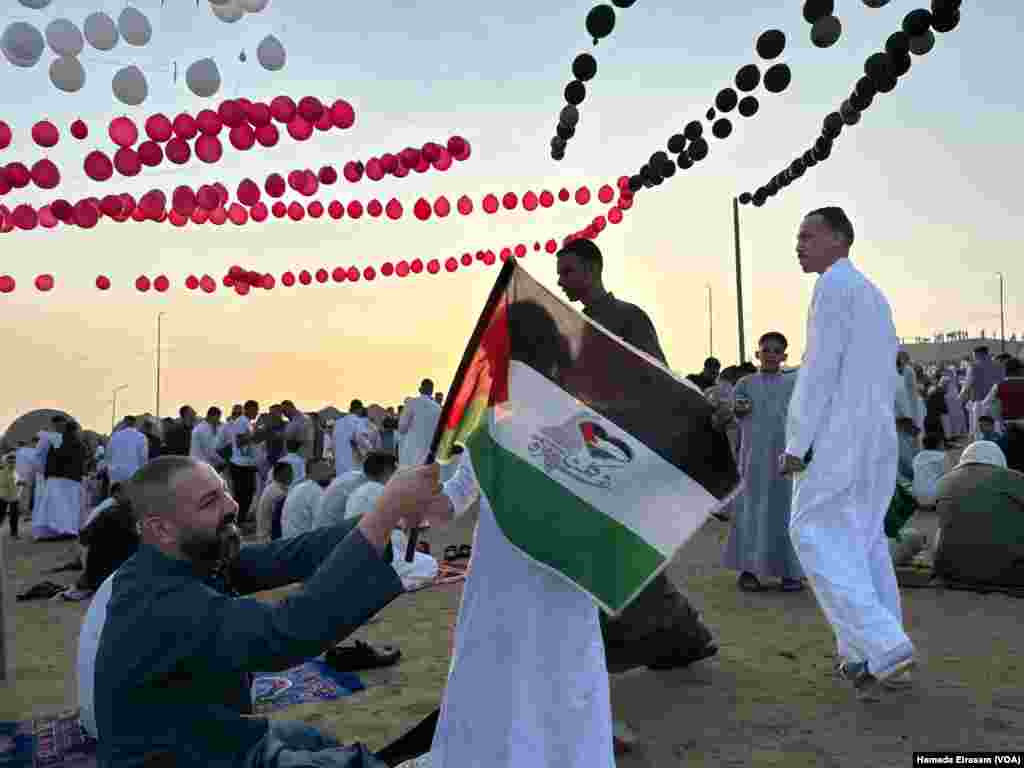 Dates, cookies, and chocolates decorated with Palestinian flags were handed out to attendees. Abusir, Egypt, April 10, 2024.