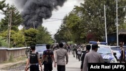 Polisi berupaya membubarkan kerumunan masa di Wamena, Papua, 23 Februari 2023. Polisi memperketat keamanan di kota Wamena, wilayah timur Papua, setelah 10 orang tewas dalam kerusuhan yang dipicu oleh desas-desus penculikan anak.(ACIZ RAZI / AFP)