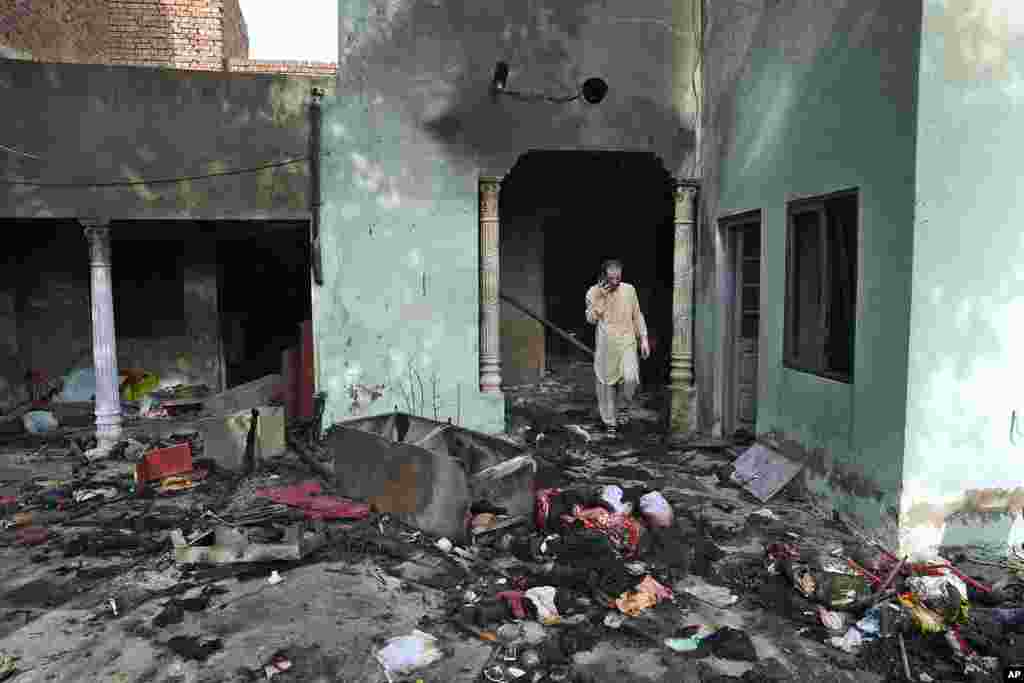 A Christian man looks at a home vandalized by an angry Muslim mob in Pakistan on Aug. 17, 2023.