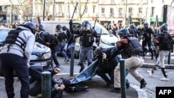 French police and demonstrators clash on the 11th day of protests after the government pushed a pension reform plan through parliament without a vote, in Toulouse, France, April 6, 2023.