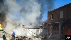 In this photo provided by the Ukrainian Emergency Service, people work to extinguish a fire following a Russian attack in Kryvyi Rih, Ukraine, Sept. 8, 2023.
