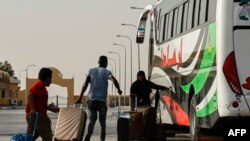 Passengers fleeing war-torn Sudan cross into Egypt through the Argeen Land Port on May 12, 2023.
