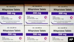 FILE - Boxes of the drug mifepristone sit on a shelf at the West Alabama Women's Center in Tuscaloosa, Ala., March 16, 2022.