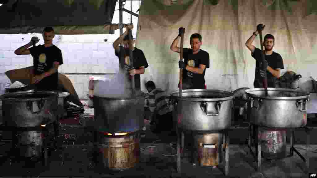 Local volunteers of the World Central Kitchen cook meals to be distributed to needy Palestinians in Rafah in the southern Gaza Strip.