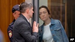 Alsu Kurmasheva, an editor for the U.S. government-funded Radio Free Europe/Radio Liberty's Tatar-Bashkir Service, listens to her lawyer during a court hearing in Kazan, Russia, May 31, 2024.