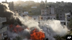 Smoke and fire rise from an explosion caused by an Israeli airstrike targeting a building in Gaza, May 13, 2023.