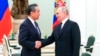 Russian President Vladimir Putin greets Chinese Communist Party's foreign policy chief Wang Yi during their meeting at the Kremlin in Moscow, Russia, Feb. 22, 2023.