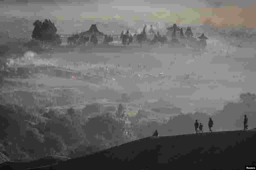Luhur Poten Temple is surrounded by dust as Tenggerese Hindu worshippers and villagers gather at Mount Bromo's crater to throw their offerings, during the Yadnya Kasada festival in Probolinggo, East Java, Indonesia.