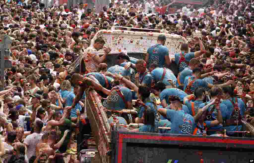 Revelers throw tomatoes at each other during the annual "Tomatina" tomato fight fiesta, in the village of Bunol near Valencia, Spain.