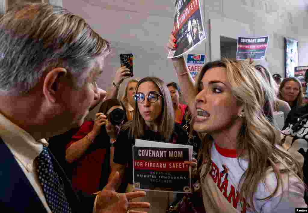 A man argues with Mary Joyce, a Covenant School mother, after the Tennessee House Republicans called for a vote to end special session on public safety to discuss gun violence in the wake of the Covenant School shooting in Nashville, Tennessee, Aug. 29, 2023. 