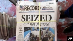 FILE - A stack of the latest weekly edition of the Marion County Record sits in the back of the newspaper's building, awaiting unbundling, sorting and distribution, Aug. 16, 2023, in Marion, Kan.