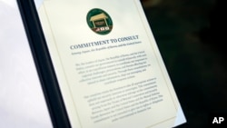 FILE - A document is displayed after a news conference between South Korea's President Yoon Suk Yeol, President Joe Biden and Japan's Prime Minister Fumio Kishida on Aug. 18, 2023, at Camp David, near Thurmont, Maryland.