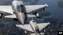 FILE - Italian Air Force Eurofighter Typhoon military fighter jets fly in Lithuanian airspace, Sept.12, 2023. German Chancellor Olaf Scholz said Saturday that a project to possibly supply Turkey with Eurofighter jets is in the early stages. 