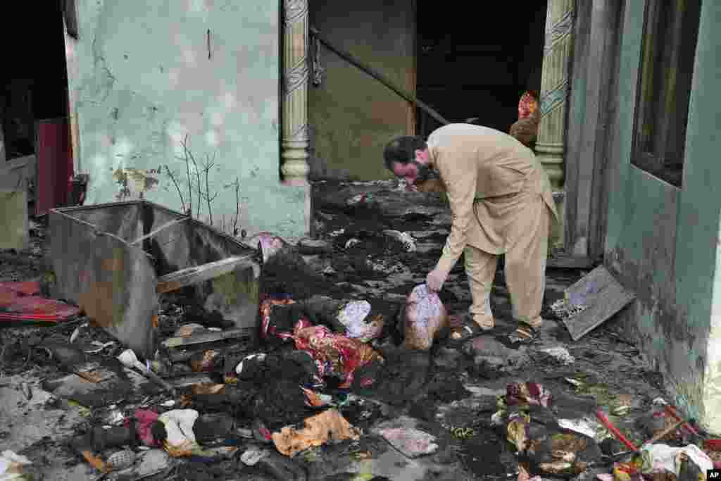 A Christian man checks a home vandalized by an angry Muslim mob in Pakistan on Aug. 17, 2023.