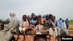Sudanese children, who fled the conflict in Murnei in Sudan's Darfur region, ride a cart while crossing the border between Sudan and Chad in Adre, Chad, Aug. 4, 2023.