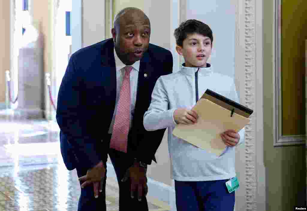 Senator Tim Scott (R-SC) looks into the Senate chamber as he gives a tour of the Senate as Senators are sworn in as jurors to decide whether the Senate will hold a full trial after receiving the two articles of impeachment against Department of Homeland Security Secretary Alejandro Mayorkas, on Capitol Hill in Washington, April 17, 2024.