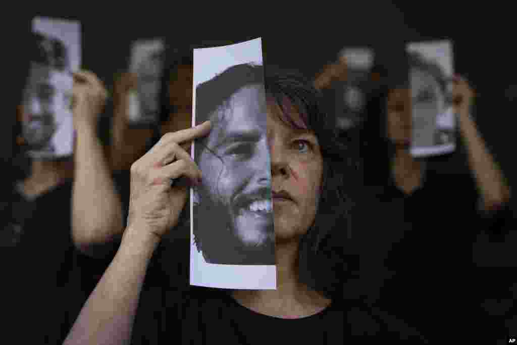 Relatives and supporters of Israeli hostages held by Hamas in Gaza, hold photos of their loved ones during a performance calling for their return in Tel Aviv, Israel.