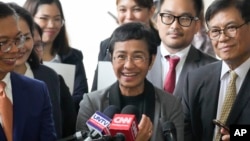 Journalist Maria Ressa, 2021 Nobel Peace Prize winner and Rappler CEO, gestures as she talks to reporters after being acquitted by the Pasig Regional Trial Court in a tax evasion case in Pasig city, Philippines, Sept. 12, 2023.