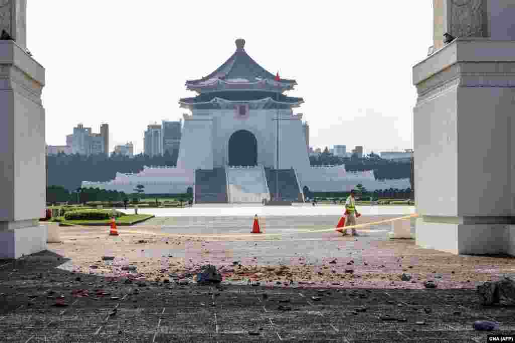 This photo taken by Taiwan's Central News Agency (CNA) on April 3, 2024 shows a barricade erected around debris in the compound of the Chiang Kai-shek Memorial Hall in Taipei after a major earthquake hit Taiwan's east. 