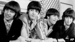 FILE - In this Aug. 23, 1966 file photo, The Beatles, from left, Ringo Starr; Paul McCartney; John Lennon; and George Harrison appear at a press conference in New York. (AP Photo)