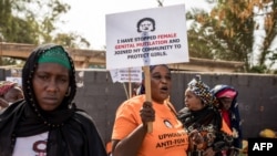 Anti-female genital mutilation (FGM) protesters demonstrate outside the National Assembly in Banjul, Gambia, March 18, 2024, as lawmakers debate a bill seeking to lift the ban on FGM. Lawmakers voted to advance the measure to the next parliamentary stage.