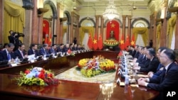 Vietnamese President Vo Van Thuong, sixth left, and Chinese President Xi Jinping, eighth right, meet at the Presidential Palace in Hanoi, Vietnam, Dec. 13, 2023. (Pool/AP)