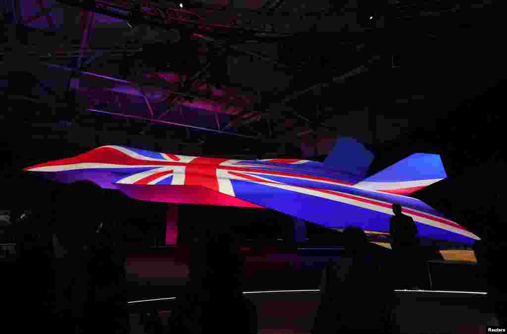 Attendees view the GCAP (Global Combat Air Program) concept model fighter plane at the BAE Systems pavilion at the Farnborough International Airshow, in Farnborough, Britain.