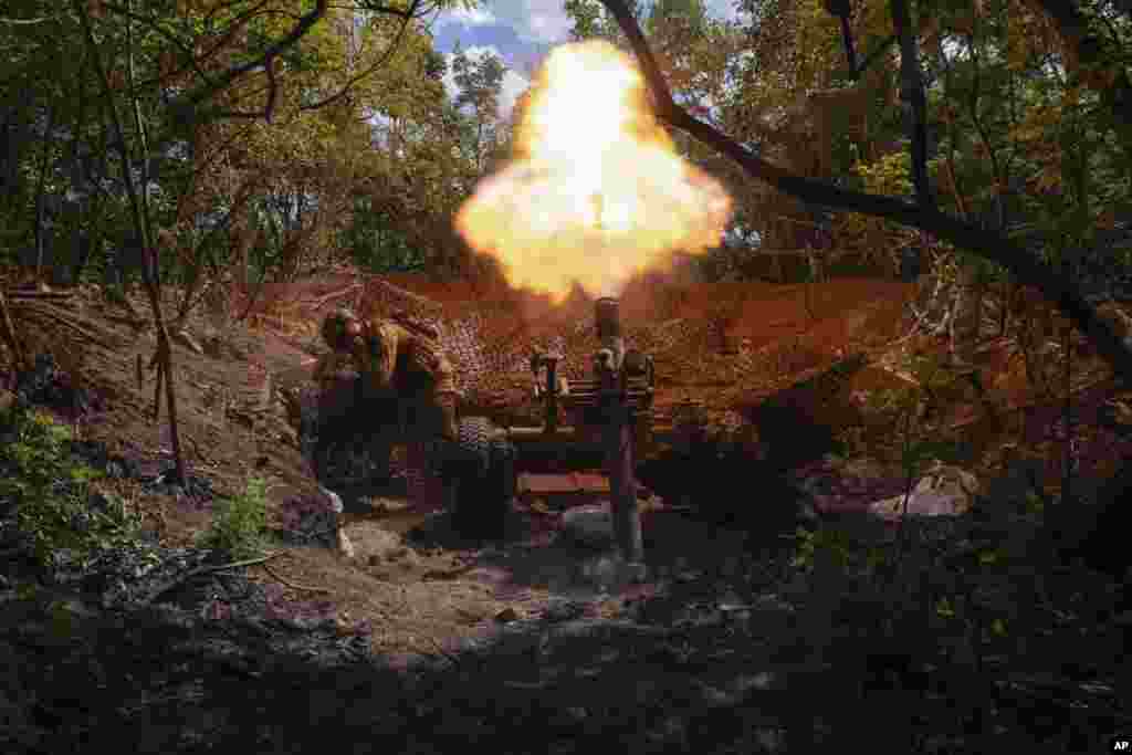Servicemen of Ukraine's 93rd Mechanised Brigade fire a French MO-120-RT heavy mortar at the Russian forces on the front line near the city of Bakhmut in Ukraine's Donetsk region.