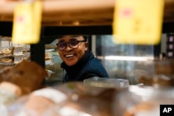 Ella Anthony smiles during an interview in the supermarket where she works, in Rome, Italy, March 26, 2024.