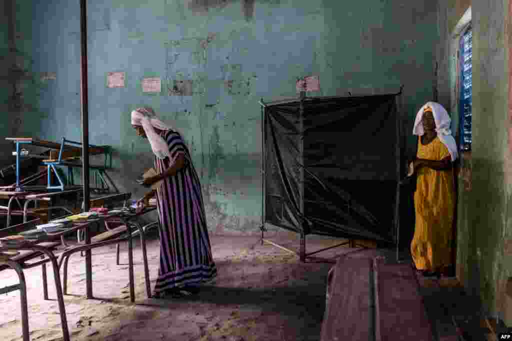 A voter leaves the voting booth at a polling station in Ziguinchor during Senegal's presidential elections.