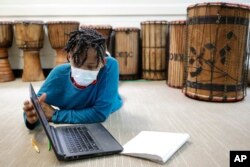 Celeste Banks, 10, of Decatur, Ga., works on a math test in class at the Kilombo Academic and Cultural Institute, March 28, 2023, in Decatur, Ga.