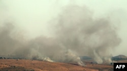 Smoke billows over hills in the Israeli-annexed Golan Heights after rockets were fired from the Lebanese side of the border, July 3, 2024. Hezbollah said it fired at two Israeli positions on July 3 after an Israeli strike in south Lebanon killed a senior commander from the group.