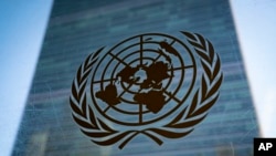 FILE - The symbol of the United Nations on display outside U.N. headquarters, Feb. 28, 2022. Six U.N. human rights experts have accused China of forcing hundreds of thousands of Tibetans into programs that threaten their cultural identity and could lead to forced labor.