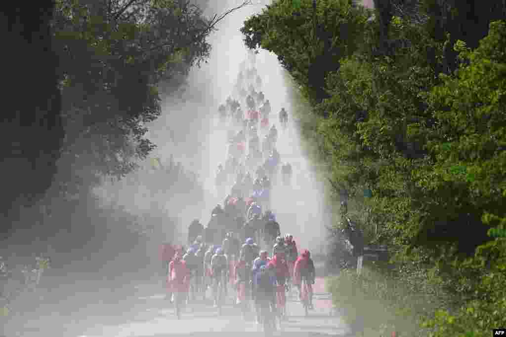 The pack rides on white roads of Tuscany during the 6th stage of the 107th Giro d'Italia cycling race, 180 km between Torre del lago Puccini and Rapolano Terme, Italy.