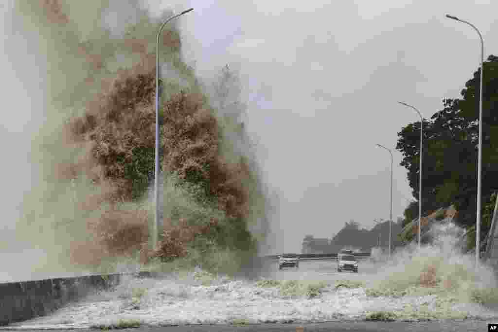 In this photo released by Xinhua News Agency, huge waves lash the shore ahead of landfall by Typhoon Gaemi in Sansha Township of Xiapu County, southeast China's Fujian Province.