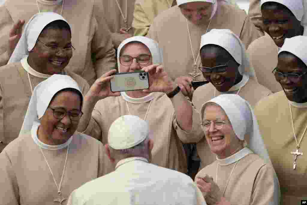 Pope Francis meets a group of nuns during his weekly general audience in the Pope Paul VI Hall at the Vatican.