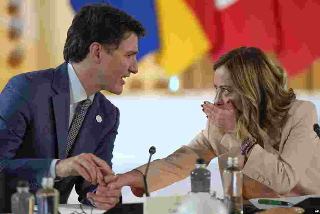 Italian Prime Minister Giorgia Meloni, right, talks to Canada's Prime Minister Justin Trudeau as they attend the Partnership for global infrastructure and investment event at the G7 summit in Borgo Egnazia, Italy.