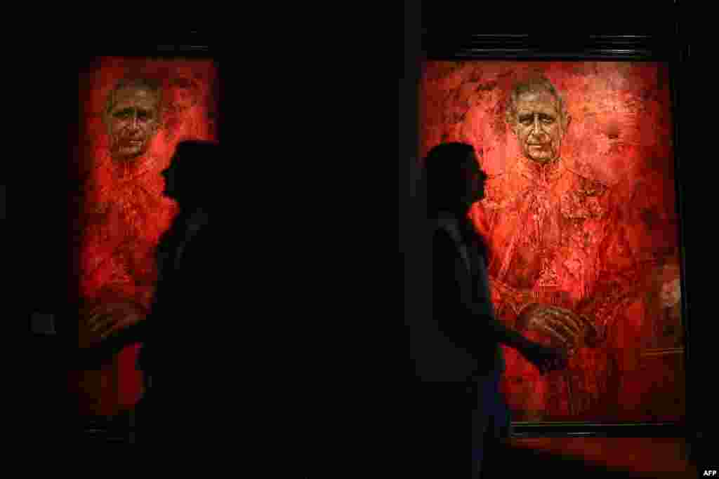 A visitor looks walks past a the new official portrait of King Charles III, painted by British artist Jonathan Yeo, and displayed at the Philip Mould gallery, on Pall Mall, central London.