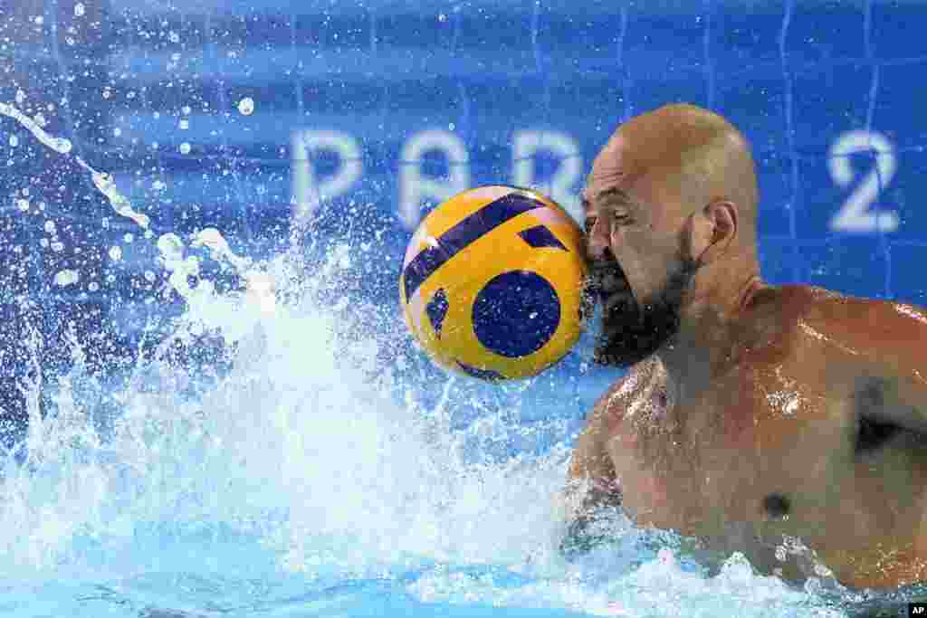 Japan's Katsuyuki Tanamura reaches for a shot during a Japan men's water polo team training session at the Olympic Aquatics Centre, ahead of the 2024 Summer Olympics in Saint-Denis, France.