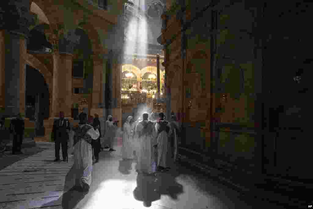 Coptic priests mark the Palm Sunday procession at the Church of the Holy Sepulchre, where many Christians believe Jesus was crucified, buried and rose from the dead, in the Old City of Jerusalem.