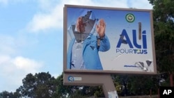 A defaced billboard of Gabon President Ali Bongo Ondimba is seen on an empty street in Libreville, Gabon, Aug. 30, 2023.