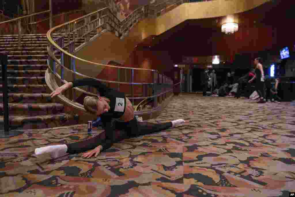 Emily Whiteford, 18, of Maryland, stretches before her audition for the Radio City Rockettes at Radio City Music Hall, April 3, 2024 in New York.