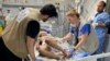 Facing horrific conditions, foreign doctors treating Gaza wounded volunteer to stay  