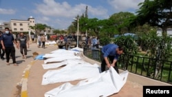 A man looks at a dead body, after a powerful storm and heavy rainfall hit Libya, in Derna, Libya Sept. 12, 2023. 